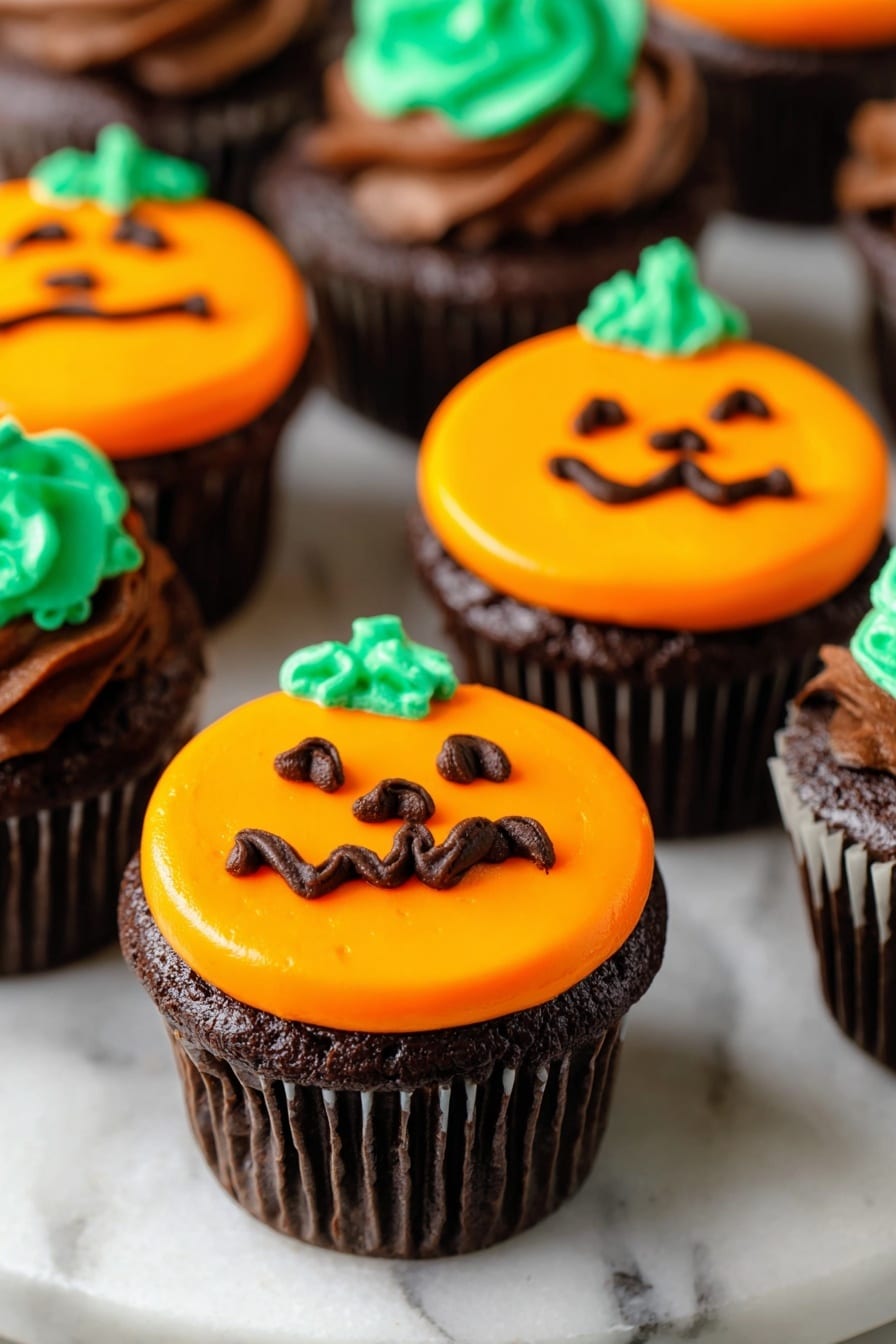 The image shows several chocolate cupcakes on a white marbled surface, each topped with bright orange frosting shaped like a pumpkin. The frosting forms one thick round layer covering the top, and each cupcake has a small swirl of green frosting at the top center to represent a pumpkin stem. The pumpkin faces are drawn with dark brown frosting, consisting of two triangular eyes, a small nose, and a wavy mouth, giving a playful Halloween look. The cupcake wrappers are dark brown, and the focus is on the front cupcakes, with others blurred softly in the background. photo taken with an iphone --ar 2:3 --v 7 - Halloween cupcake collection, Halloween themed decorated cupcakes, spooky Halloween cupcake ideas, Halloween party cupcakes, festive Halloween baking recipes