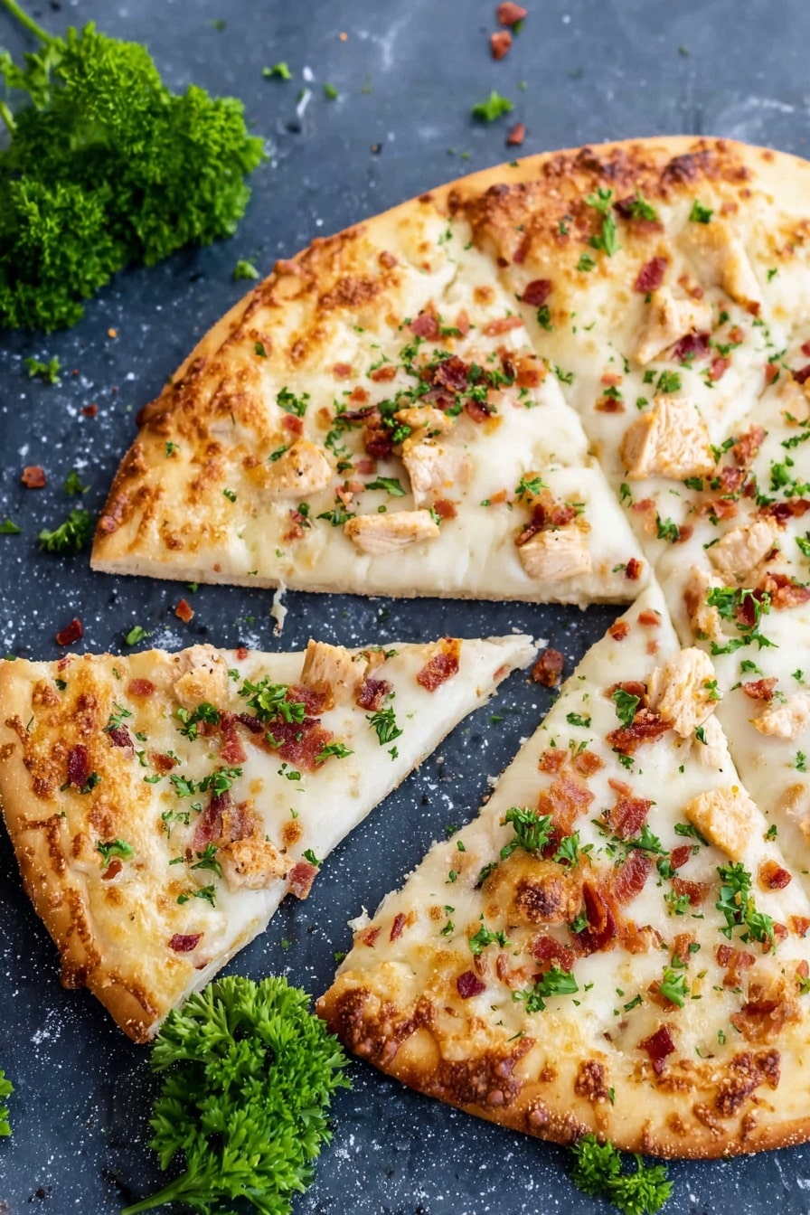 A pizza with a golden crust is shown on a dark blue stone surface, with one slice slightly pulled away. The pizza has three layers: a thin crust, a thick white cheese layer with a smooth and melted texture, and small pieces of light brown chicken and tiny bits of red bacon scattered on top. There are also small green parsley leaves sprinkled over the pizza. Around the pizza, there are fresh parsley sprigs and crumbs. The background is changed to a white marbled surface. photo taken with an iphone --ar 2:3 --v 7 - Chicken Alfredo Pizza, Creamy Alfredo Pizza, Easy Chicken Pizza, Homemade Alfredo Pizza, Cheesy Chicken Pizza