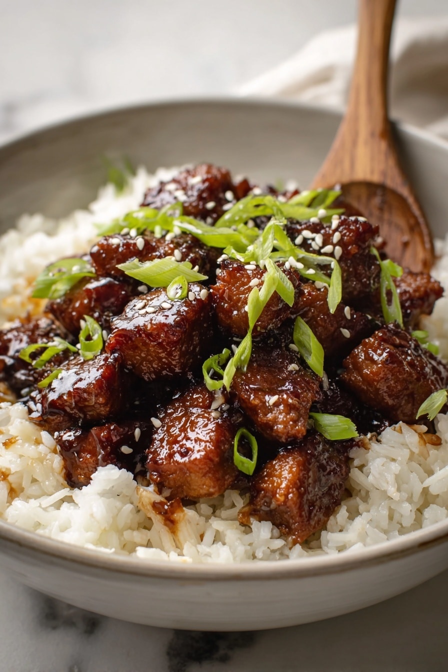 A close-up image of a dish with three layers, served in a white bowl on a white marbled surface. The bottom layer is fluffy white rice, with some small pieces of light brown onions mixed in. The middle layer consists of many chunks of glazed dark brown cooked meat, arranged in a small pile on top of the rice. The meat has a shiny texture from the sauce coating. The top layer is sprinkled with light green sliced scallions and a few white sesame seeds scattered evenly. A wooden spoon is tucked slightly under the meat on the right side. Photo taken with an iphone --ar 2:3 --v 7 - Honey BBQ Chicken Thighs, Honey BBQ Chicken, Chicken and Rice Dinner, Easy BBQ Chicken Recipe, Juicy Chicken with Honey BBQ Sauce