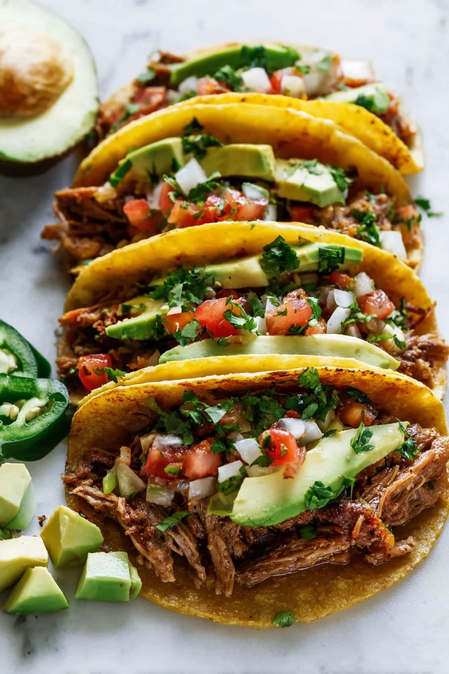 Three tacos are lined up closely on a white marbled surface, each with a soft, warm yellow corn tortilla. The first bottom layer inside the taco is shredded cooked meat with a brown and slightly crispy texture. On top of the meat, there are small colorful cubes of diced tomato and white onion, sprinkled with green chopped cilantro. Slices of fresh green jalapeño peppers and chunks of creamy green avocado sit on top. Around the tacos, there are slices of whole avocado and a few small avocado cubes scattered on the white marbled surface. The photo taken with an iphone --ar 2:3 --v 7 - Easy Slow Cooker Carnitas, slow cooker pork recipes, Mexican pork dishes, tender carnitas, flavorful pork tacos