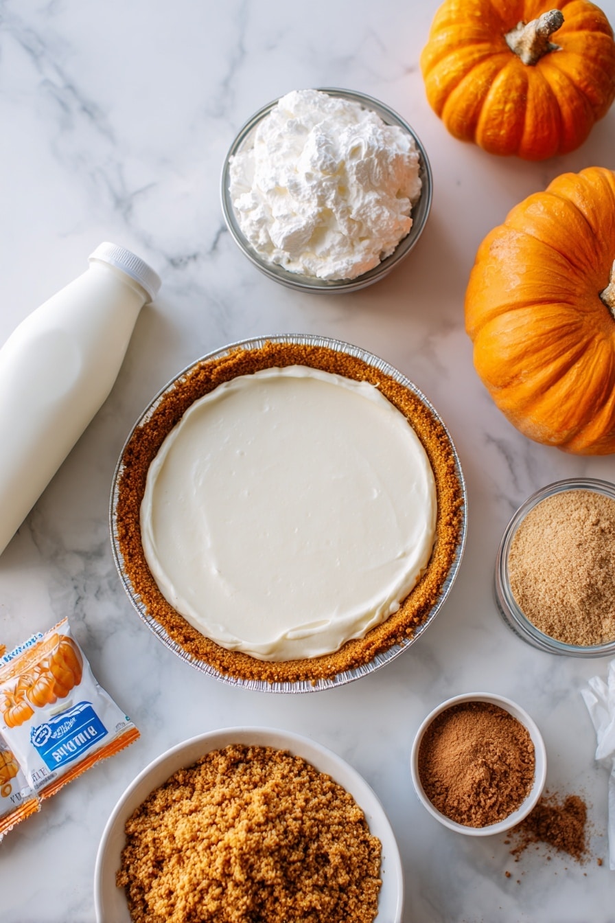 Flat lay of smooth cream cheese, a small carton of milk, powdered vanilla pudding mix packets, fluffy Cool Whip topping, a can of vibrant orange pumpkin, warm brown pumpkin pie spice powder, golden graham cracker crumbs, and a premade graham cracker pie crust, all beautifully arranged with soft natural light highlighting their textures, placed on a white marble surface, photo taken with an iphone --ar 2:3 --v 7 - No Bake Pumpkin Pie, easy pumpkin pie dessert, fall no bake pie, creamy pumpkin pie, Thanksgiving dessert