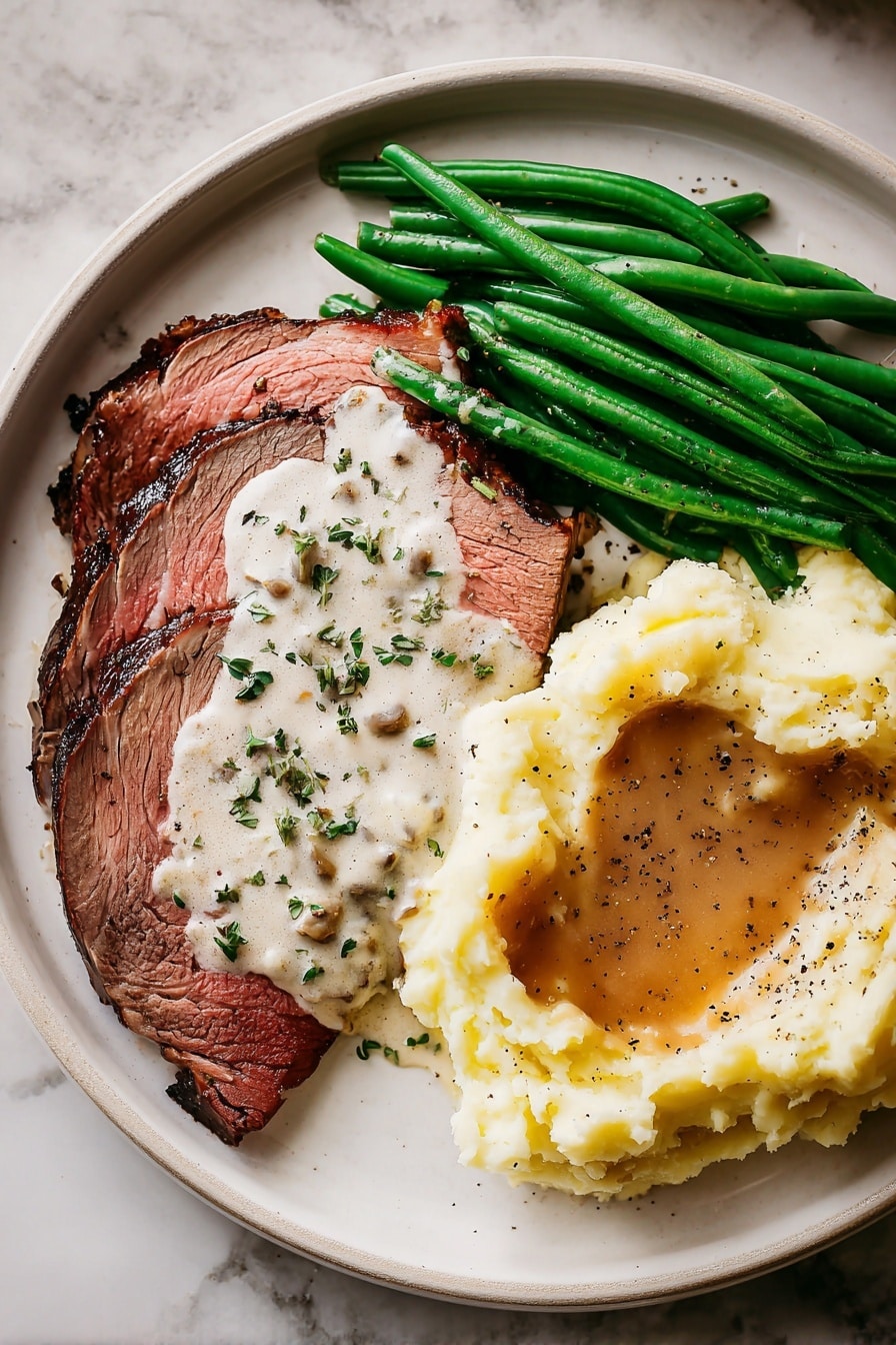 On a white plate, there are four thick slices of roast beef with a brown outer crust and a pink inside showing they are cooked medium rare. The beef has fat on the edges that is creamy white and shiny. Brown beef juices are drizzled on top, adding shine and moisture. A small white bowl sits on the plate near the bottom left, filled with creamy white horseradish sauce topped with small green chive pieces and a small metal spoon inside. Fresh green rosemary sprigs lay beside the roast beef under the sauce bowl. The whole setting is on a white marbled surface with a beige cloth napkin just visible at the bottom right corner. Photo taken with an iphone --ar 2:3 --v 7 - Reverse Sear Prime Rib, Prime Rib cooking tips, How to cook prime rib, Perfect prime rib crust, Juicy prime rib method