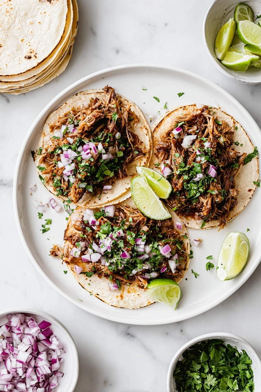 The image shows three open soft corn tortillas on a white round plate, each layered with a generous amount of shredded, browned meat that looks tender and slightly crispy; on top of the meat, finely chopped red onions and fresh green cilantro are sprinkled evenly, adding a pop of color. Two lime wedges sit on the plate next to the tacos. Around the plate, on a white marbled surface, are small white bowls containing more lime wedges, chopped red onions, and cilantro, along with a stack of soft tortillas. The scene is bright and clean, emphasizing fresh ingredients and simple presentation. photo taken with an iphone --ar 2:3 --v 7 - Slow Cooker Carnitas Tacos, Crispy Pork Tacos, Easy Carnitas Recipe, Pork Tacos with Fresh Toppings, Tender Pulled Pork Tacos