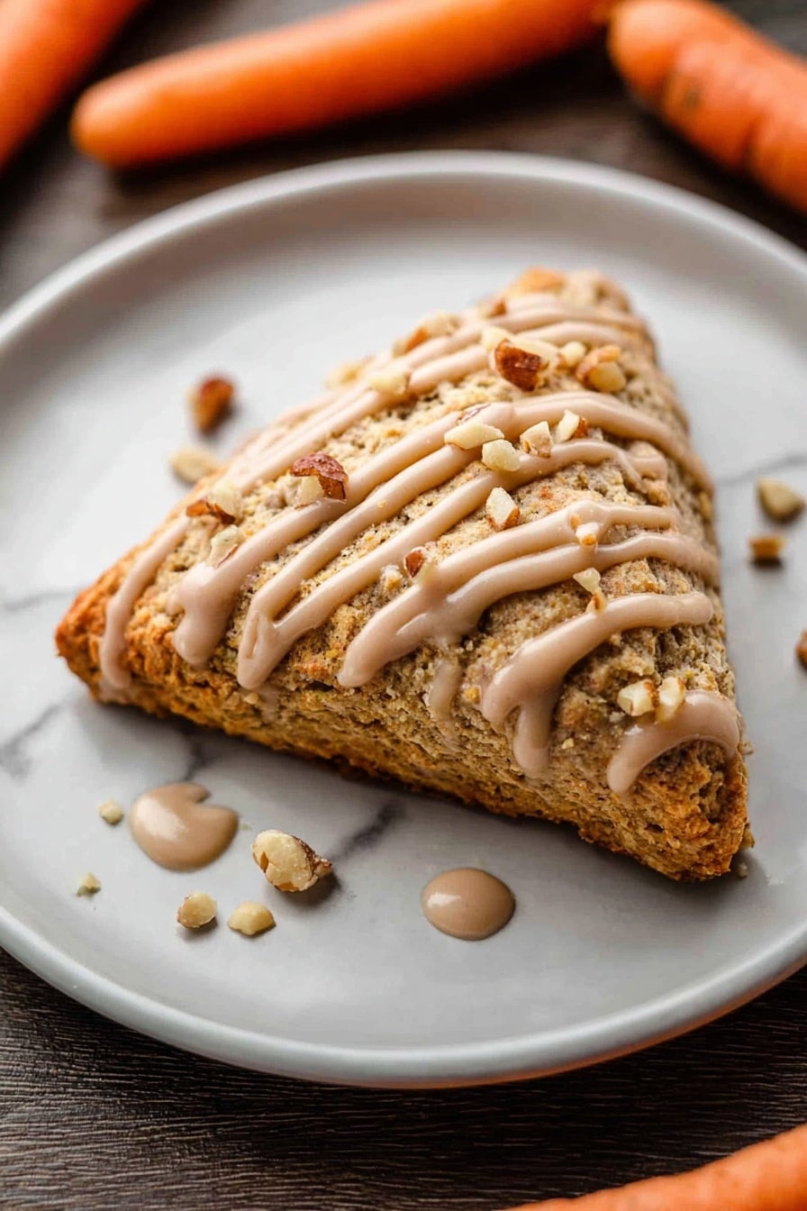 A thick square slice of carrot cake sits in the middle of a white plate on a white marbled surface. The cake has two visible layers, light brown with small orange carrot pieces inside. A light brown creamy frosting is drizzled on top in a zigzag pattern and sprinkled with small walnut pieces. A gold fork on the right side holds a bite of the cake with frosting, showing its soft and moist texture. Around the plate are scattered walnut bits and two whole carrots blurred in the background. photo taken with an iphone --ar 2:3 --v 7 - Carrot Cake Scones with Cinnamon Glaze, easy carrot cake scones, flaky scones with cinnamon glaze, homemade carrot cake scones, spice-infused scone recipes