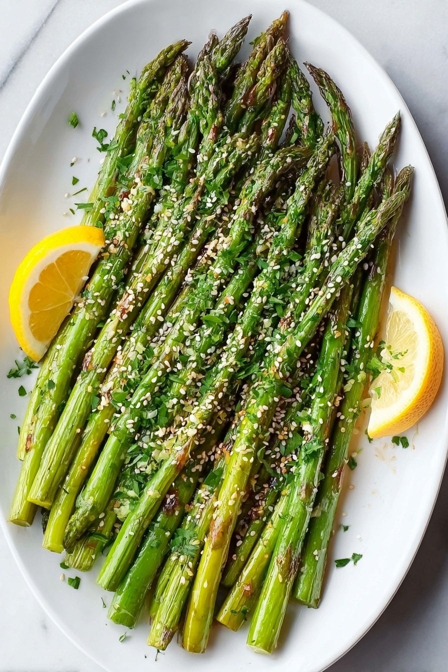A white oval plate holds a neat pile of green asparagus spears spread in one layer, with some edges showing slight brown grill marks, sprinkled generously with small white sesame seeds and finely chopped fresh green herbs. There are two bright yellow lemon slices placed at opposite sides of the plate, resting on a white marbled surface. The overall look is fresh, vibrant, and simple with a focus on natural colors and textures. photo taken with an iphone --ar 2:3 --v 7 - Garlic Parmesan Roasted Asparagus with Lemon, roasted asparagus side dish, easy vegetable recipes, healthy asparagus ideas, lemon garlic asparagus