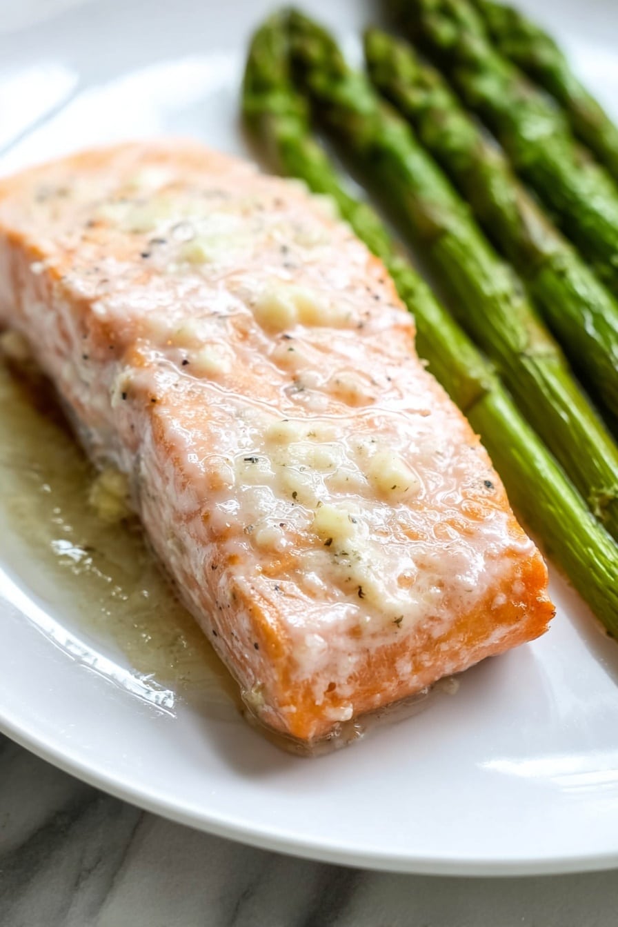 The image shows a baking tray lined with light brown parchment paper on a white marbled surface. On the parchment paper, there are six pieces of cooked salmon fillets, arranged in a scattered pattern. The salmon is light pink with some white and golden brown spots, showing a slightly crispy texture on top. Alongside the salmon, there are bright green asparagus spears, placed mostly in groups on the left and right sides of the tray. The asparagus looks tender and slightly roasted with a few charred spots. The overall look is fresh and simple, showcasing the salmon and asparagus in a neat and natural layout. photo taken with an iphone --ar 2:3 --v 7 - One-Pan Baked Salmon and Asparagus, baked salmon asparagus, healthy salmon dinner, easy salmon recipes, quick weeknight salmon